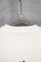 Cream knit sweater back with crewneck collar ribbing