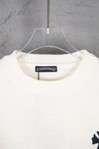 Cream knit sweater neckline with ribbed crewneck and hanging tag