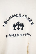 Cream long-sleeve sweater front with dark graphic and crosses