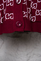 Burgundy knit cardigan with white Gucci logo pattern and button front