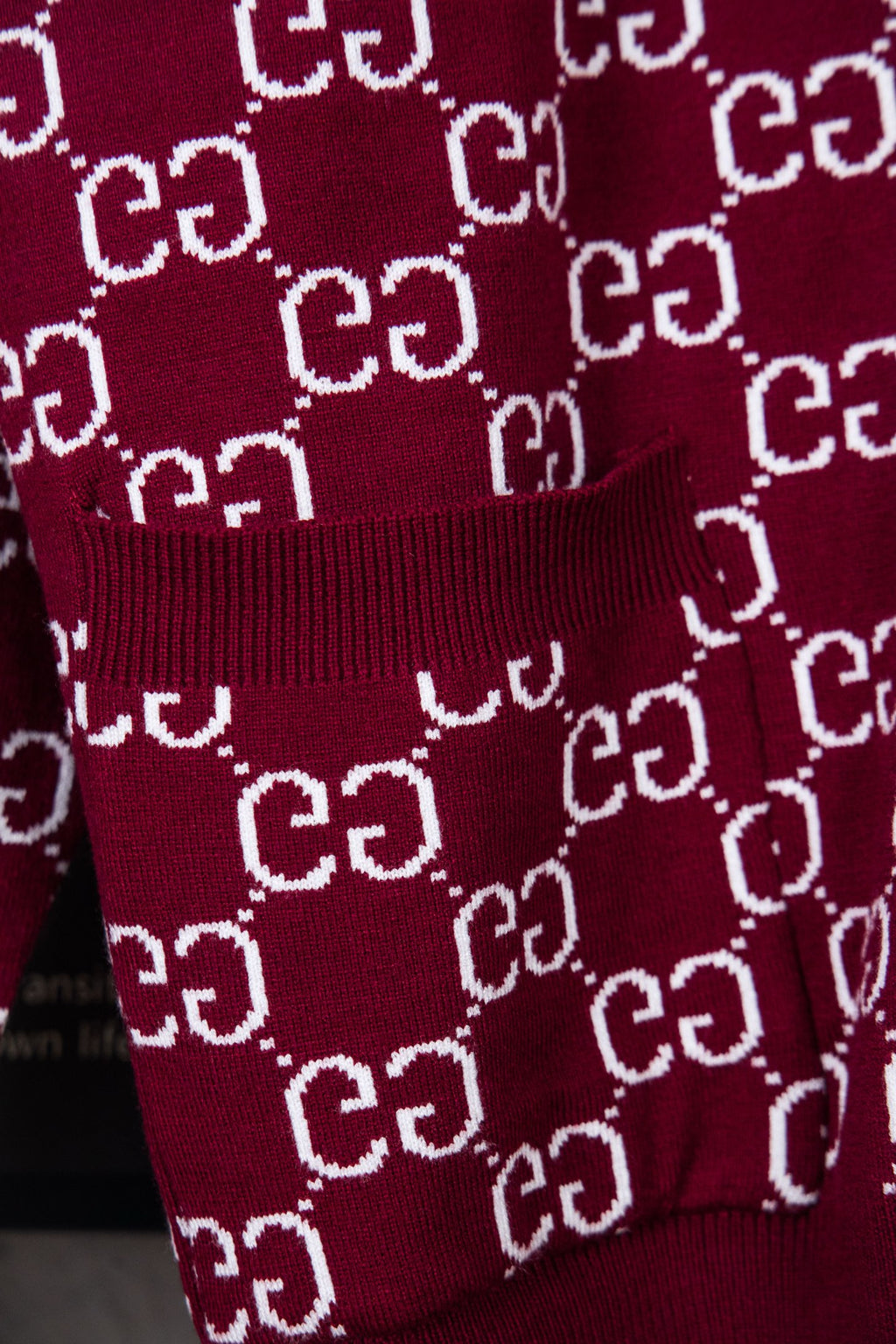 Gucci burgundy knit sweater with ribbed hem and repeating white GG pattern