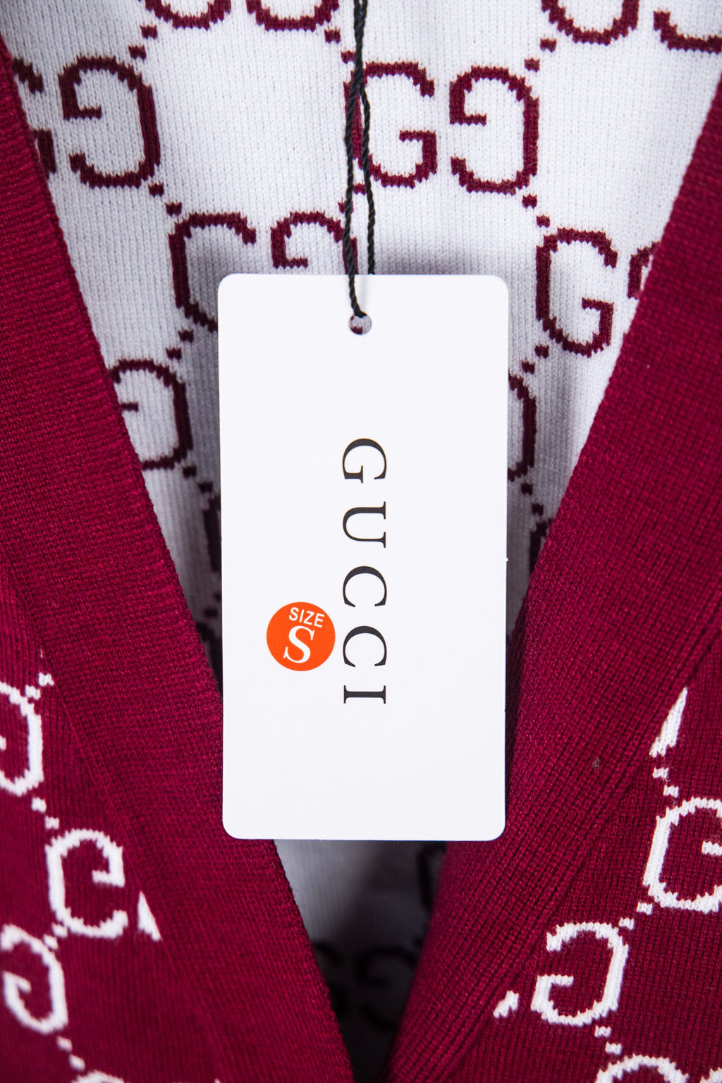 Gucci knit sweater with burgundy fabric and white GG pattern; size tag shows S