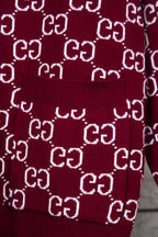 Gucci knit sweater with ribbed cuff and hem on burgundy fabric; white GG pattern