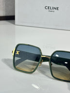 Celine sunglasses close-up with dark green frames and blue-tinted lenses, gold logo