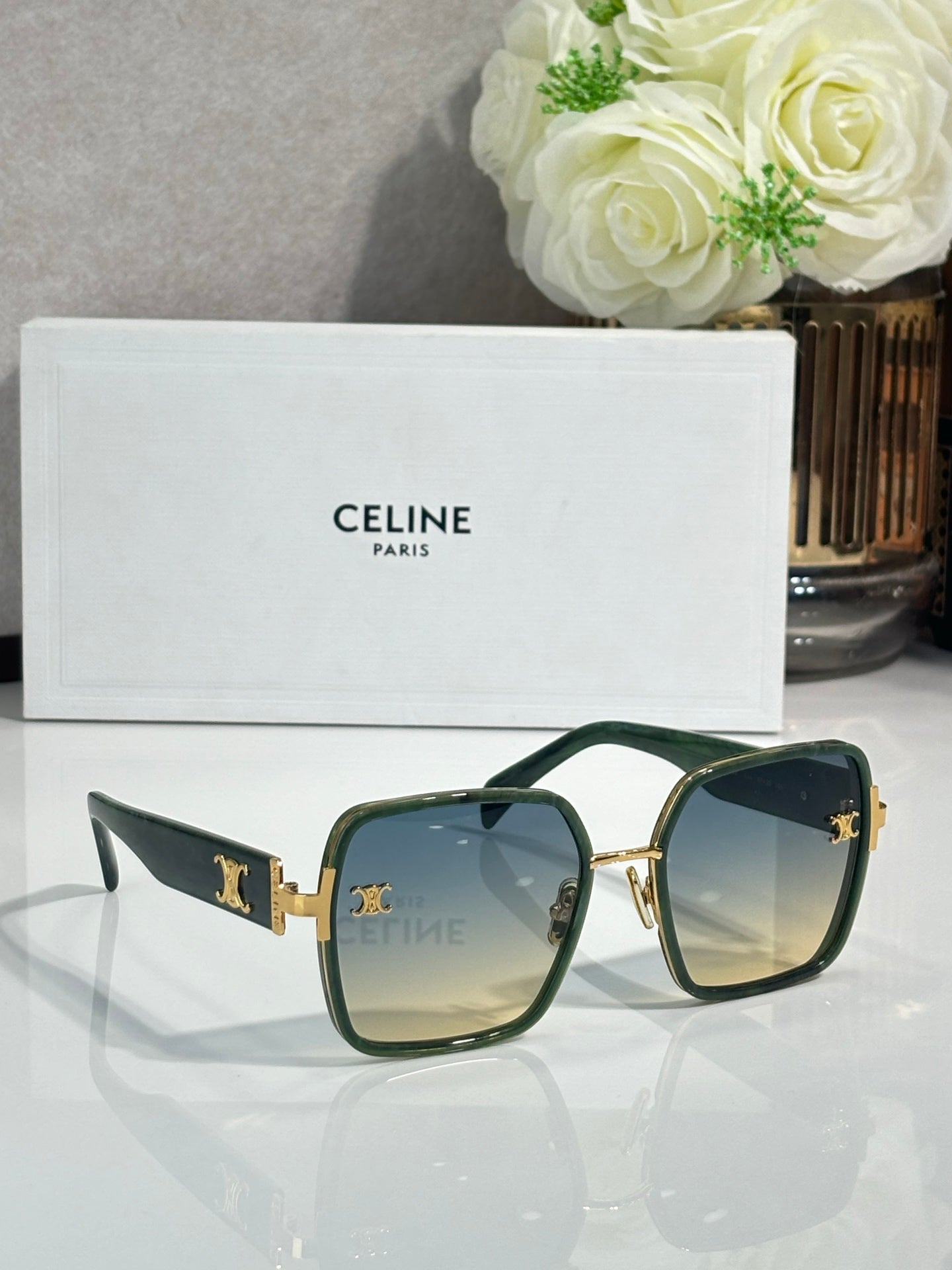 Celine sunglasses with dark green square frames, gold-tone hinges and logo