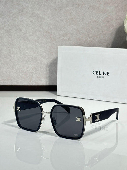 Celine sunglasses with dark frames and black lenses, gold-tone logo on arms