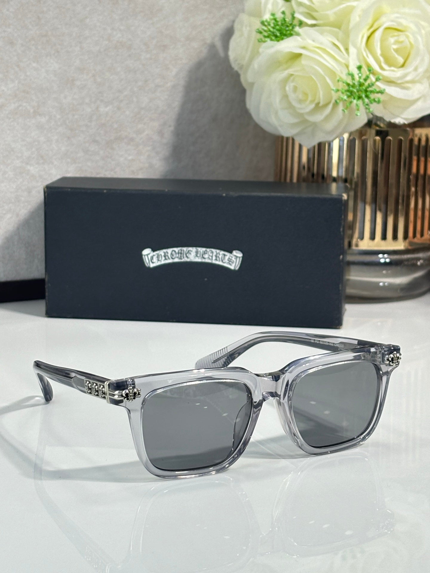 Chrome glasses with silver frame, gray lenses, decorative metal bridge detail