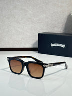 Chrome glasses with dark tortoise frame, amber-brown lenses, gold emblem on temple