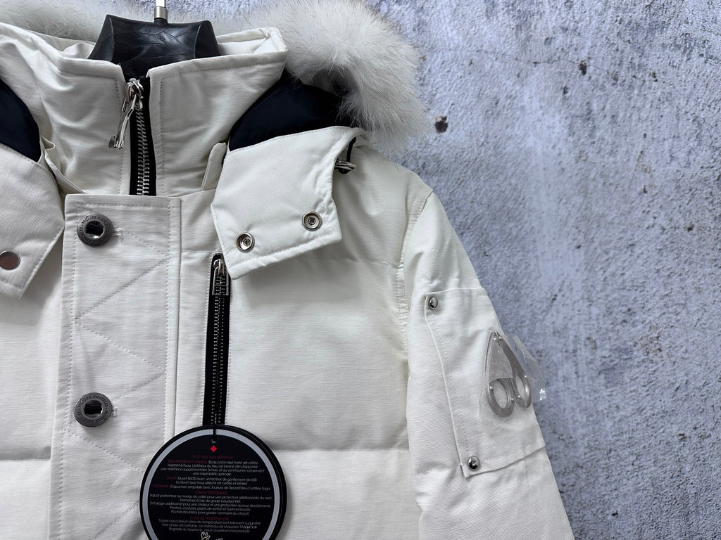 White puffer jacket close-up with hood trim, snap buttons, and zipper placket