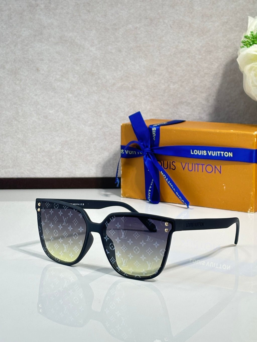 Louis Vuitton sunglasses, black frames, dark mirrored lenses with LV monogram