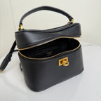 Balenciaga mini bag front view in black leather with gold zipper and logo hardware