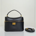 Balenciaga mini bag in black leather with top handle, gold clasp, and zip closure