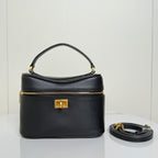 Balenciaga mini bag in black leather with top handle, gold clasp, and zip closure