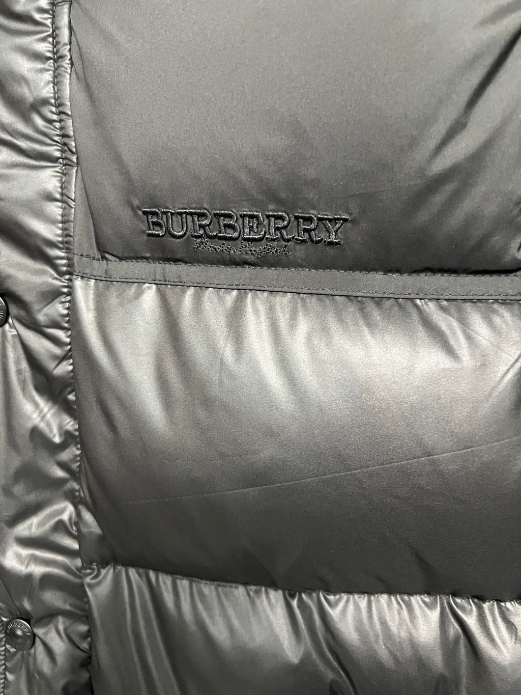 Burberry logo patch on black puffer jacket front panel