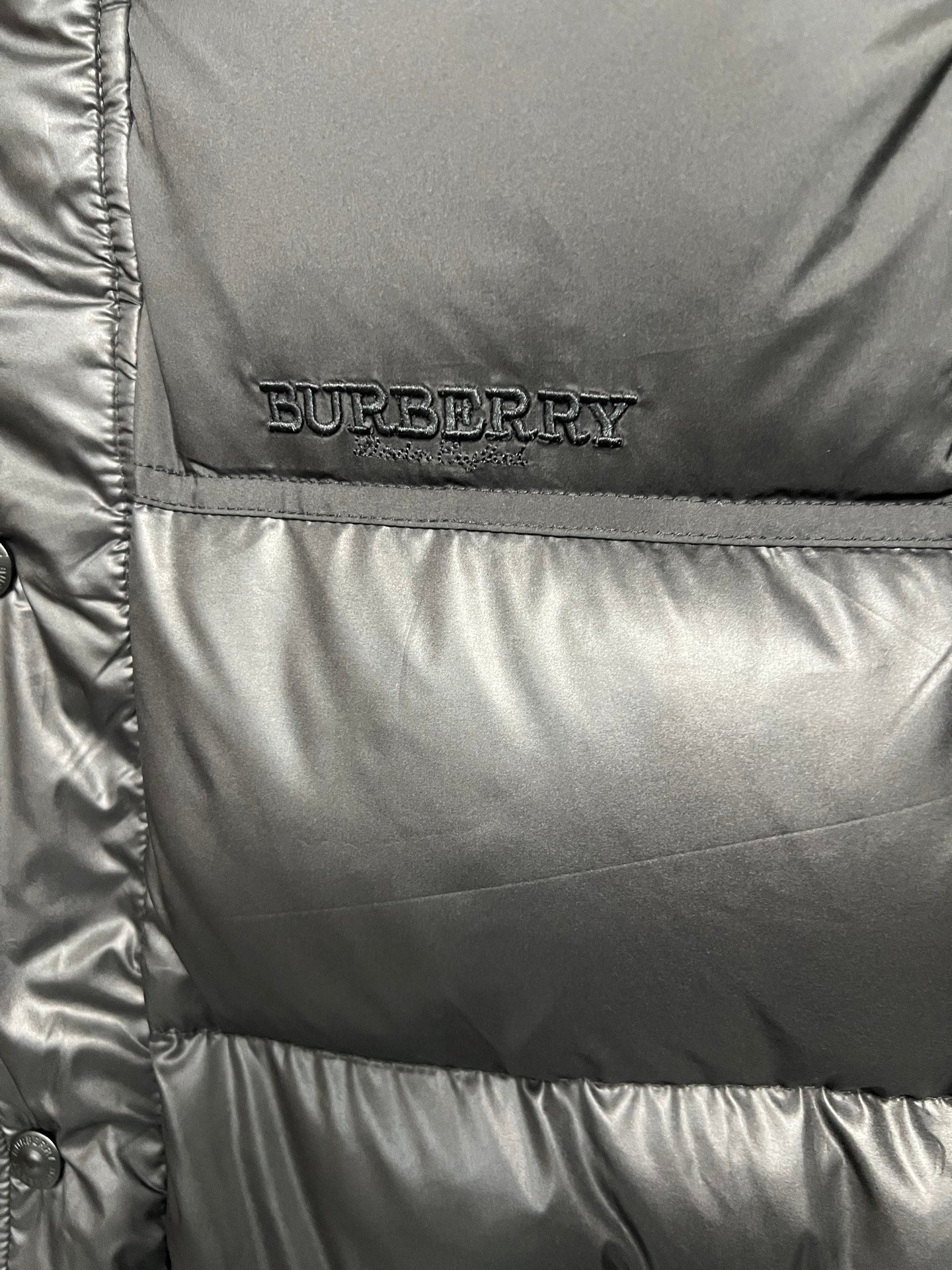 Burberry logo patch on black puffer jacket front panel