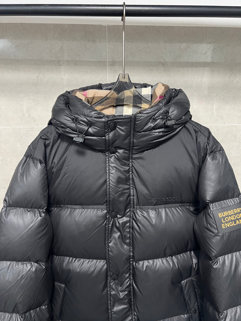 Black puffer jacket with chin-guard zipper and hood, Burberry England label