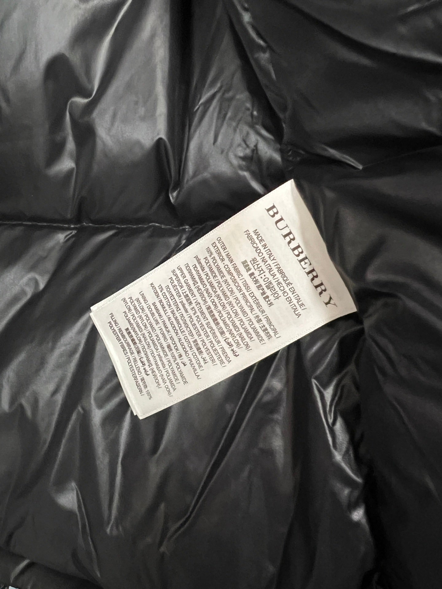 Burberry care label tag on black puffer jacket interior lining