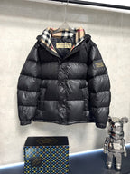 Black puffer jacket with plaid-lined hood and front zipper, quilted design