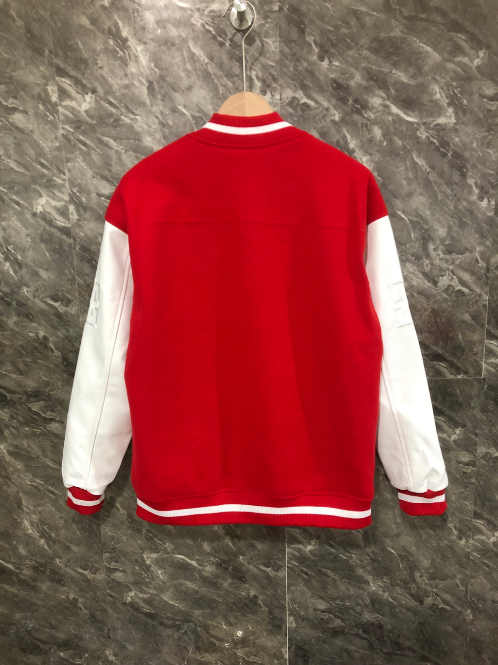Givenchy red varsity jacket back view with white sleeves and striped hem trim