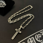 Two silver-tone chain necklaces with cross pendants on a dark background