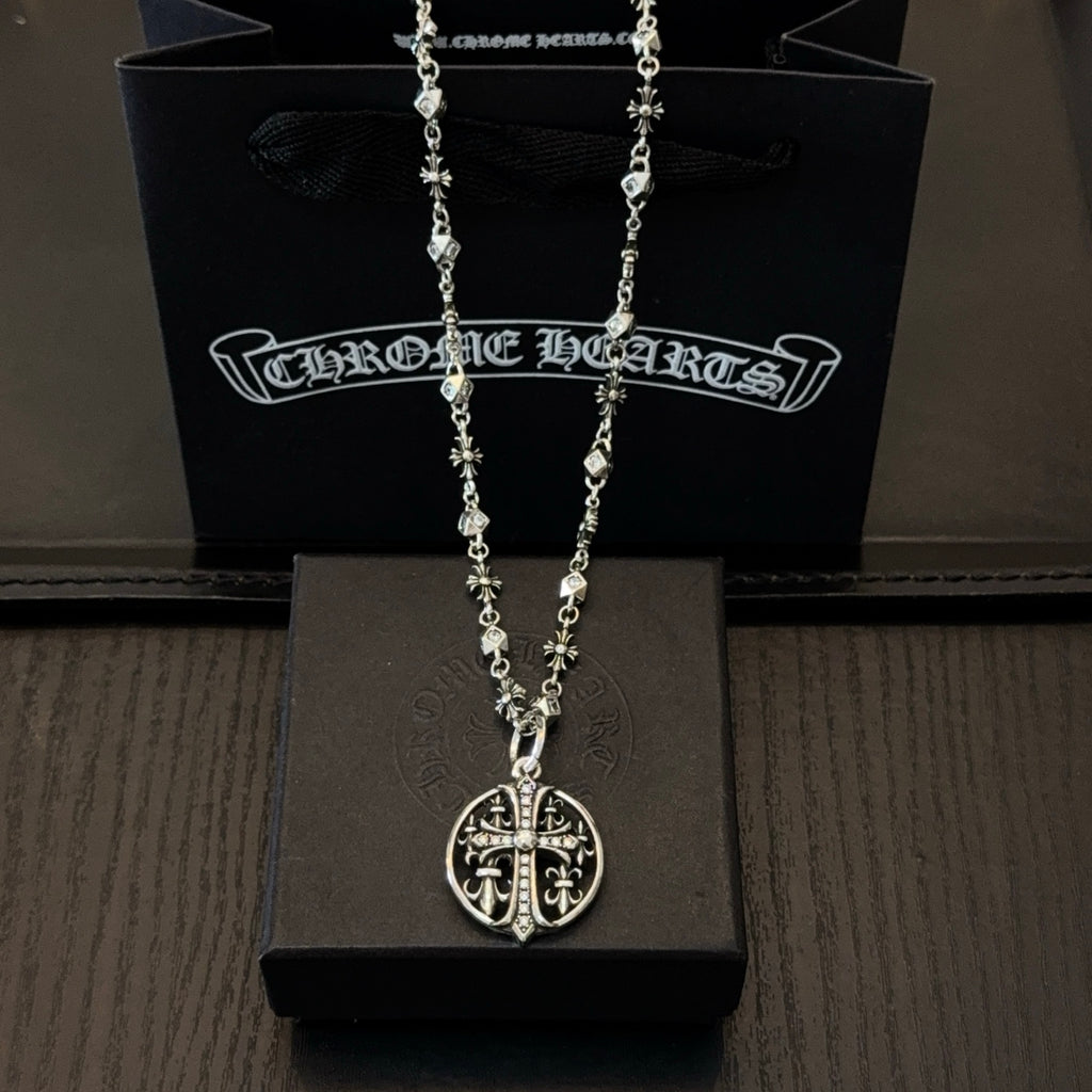 Silver-toned necklace with oval cross pendant and charm-link chain