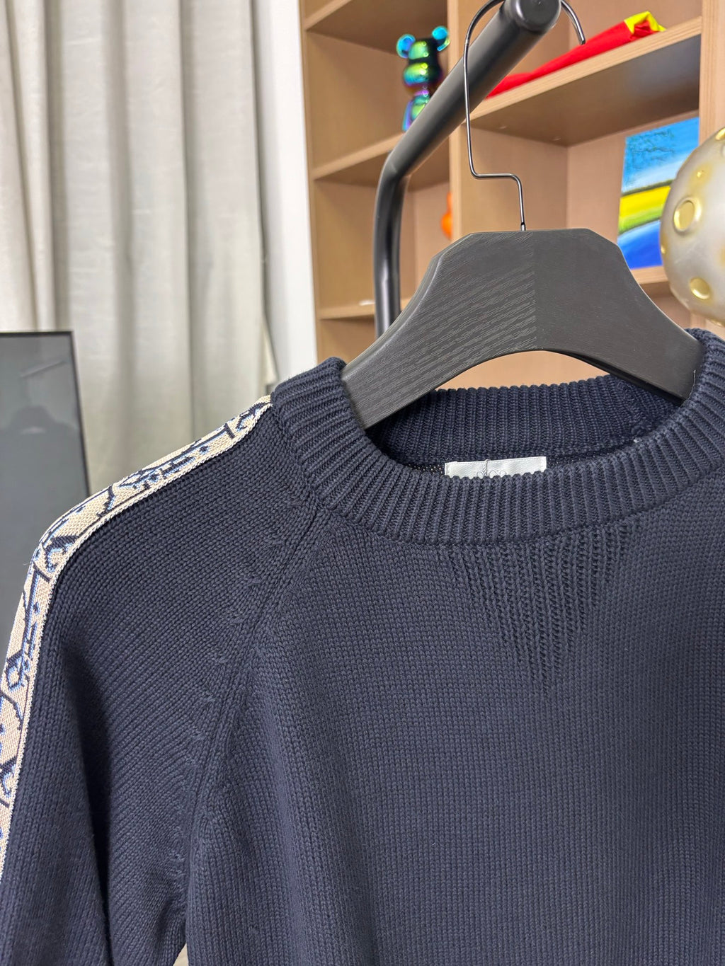 Dior long-sleeve knit sweater close-up, dark navy textured knit crew neck