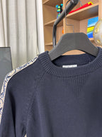 Dior long-sleeve knit sweater close-up, dark navy textured knit crew neck