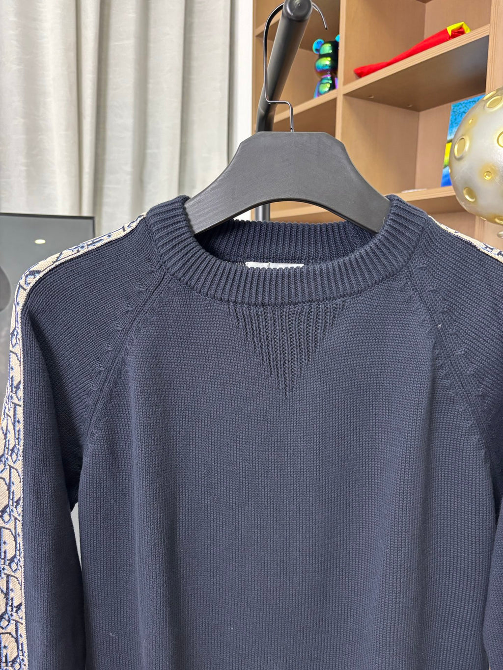 Dior long-sleeve knit sweater close-up, dark navy ribbed crew neck