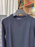 Dior long-sleeve knit sweater close-up, dark navy ribbed crew neck