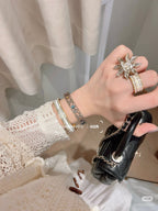 Stacked rhinestone bracelets in gold and silver tones on wrist