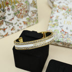 Gold-tone Christian Dior cuff bracelet with black enamel center and crystal pavé edge