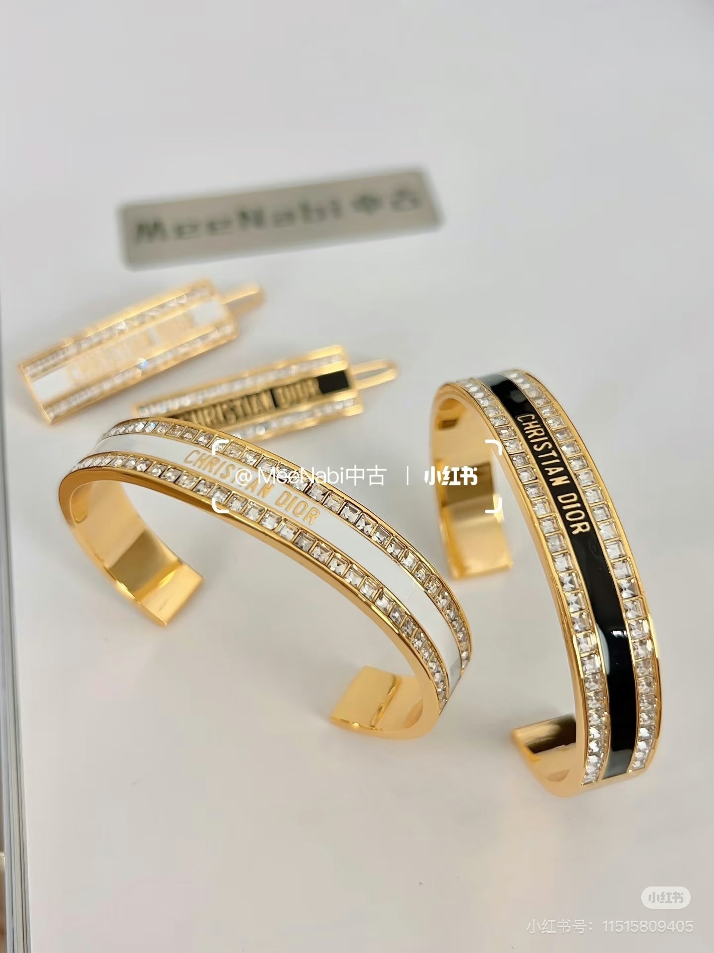 Gold-tone crystal pavé Christian Dior cuff bracelets with black enamel center stripe
