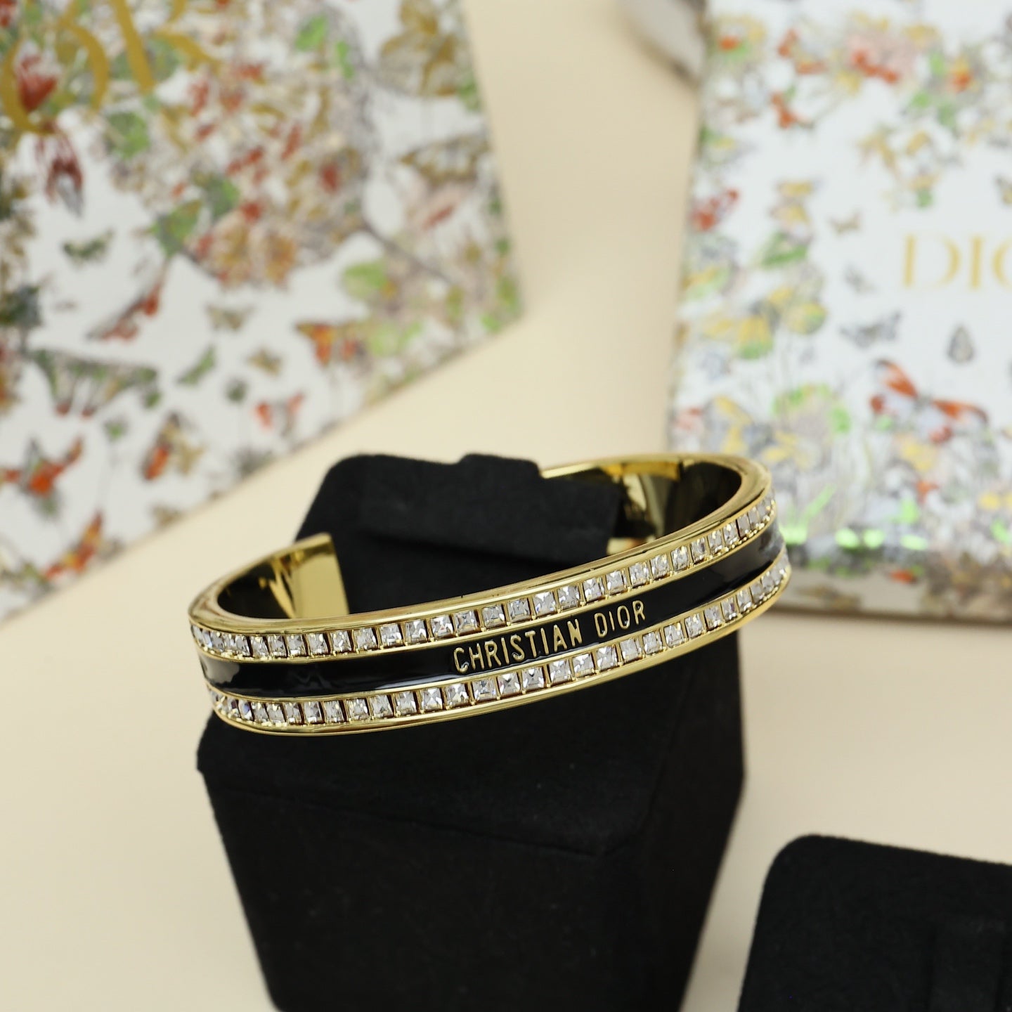 Gold-tone Christian Dior cuff bracelet with black enamel center and rhinestone pavé trim