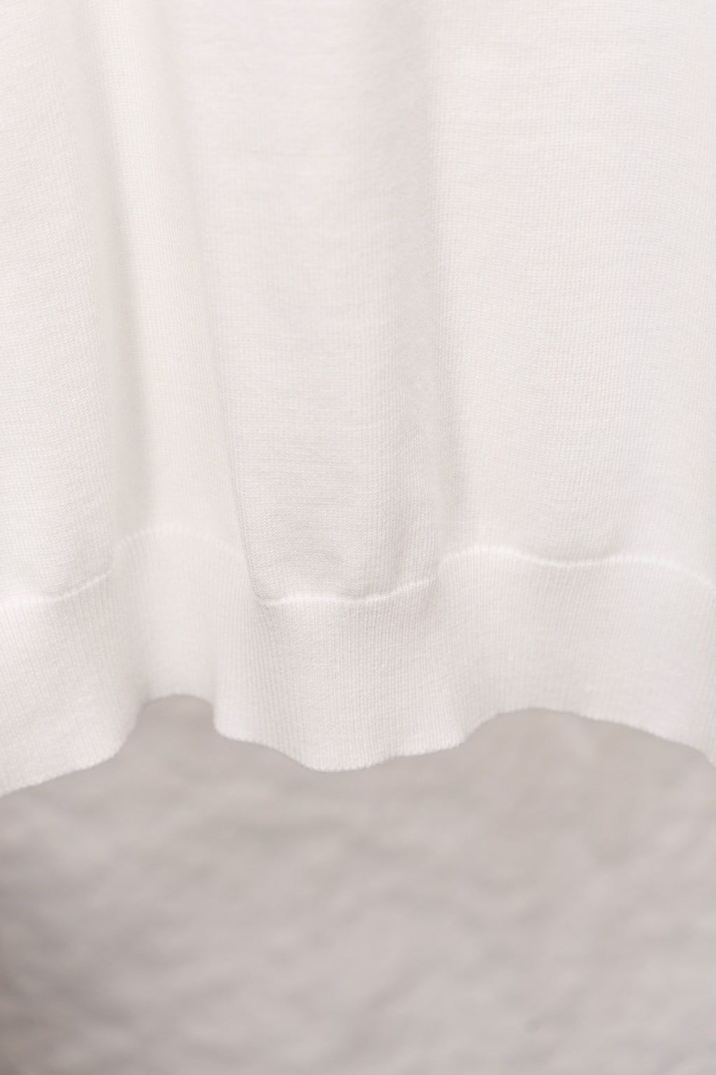 White sweater ribbed hem with soft drape