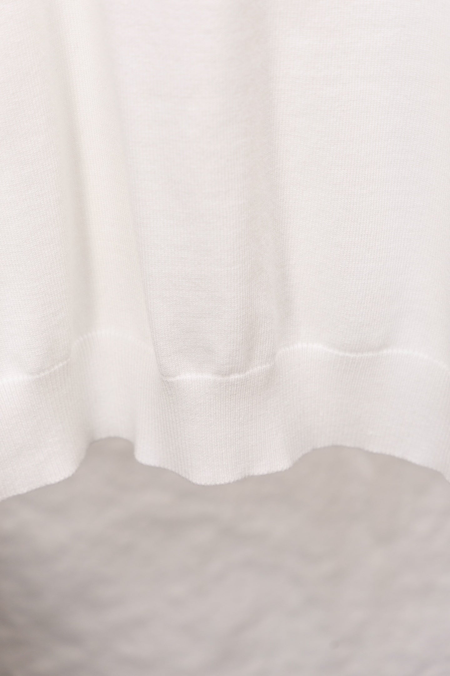 White sweater ribbed hem with soft drape