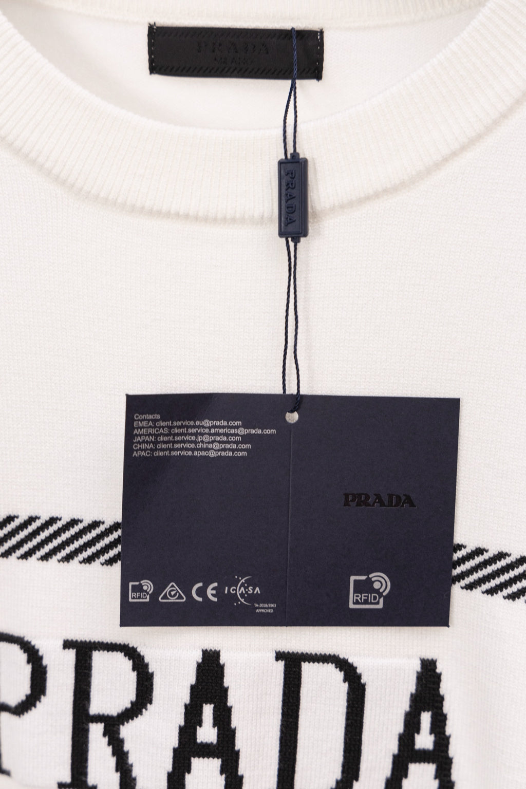 PRADA white sweater neckline with black label and hanging tag