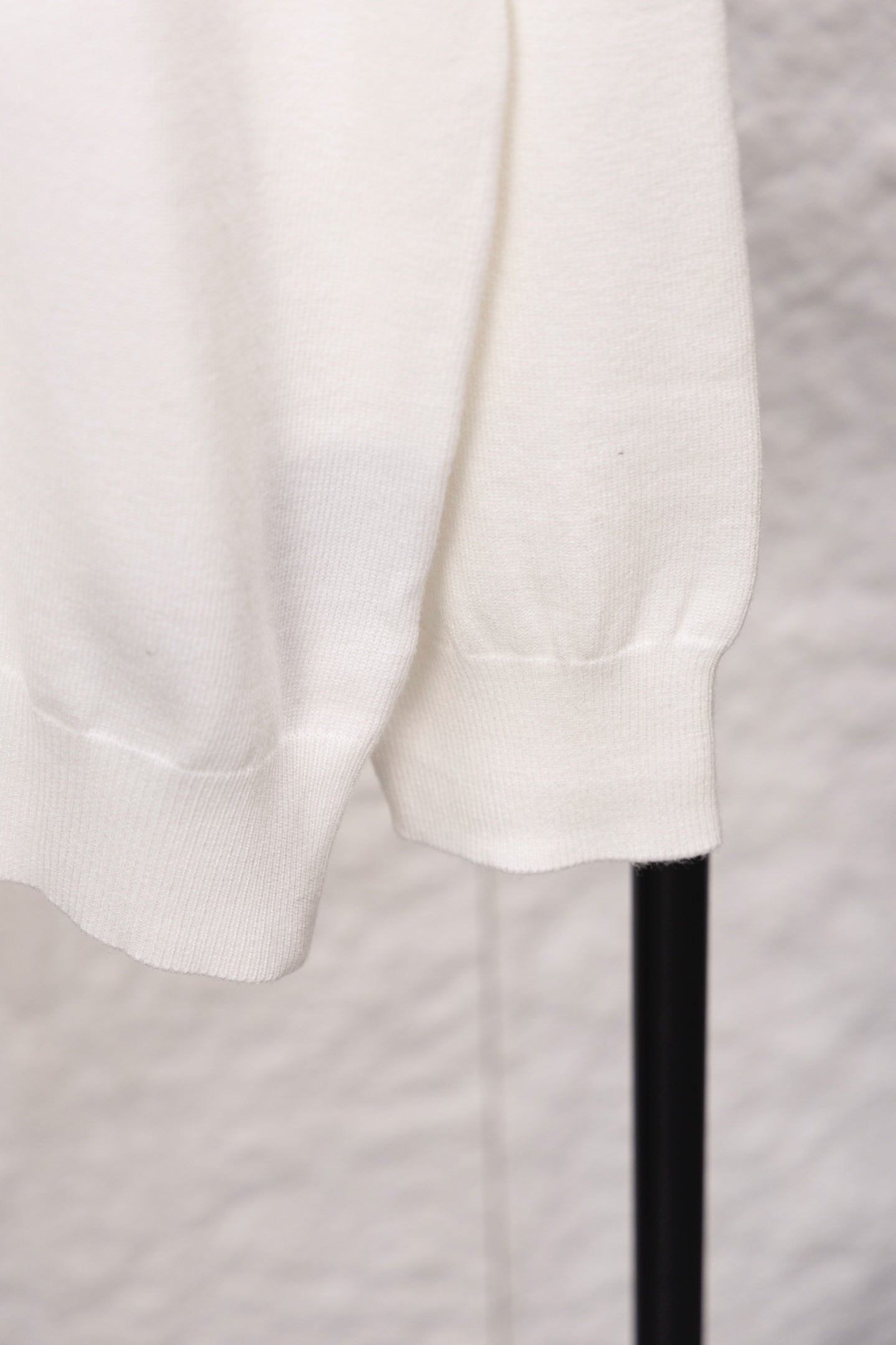 White sweater hem and ribbed cuff detail