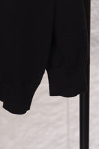 Black sweater lower sleeve and hem with ribbed knit cuffs