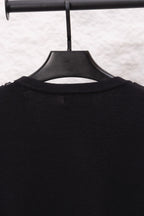 Close-up of black sweater upper back on hanger