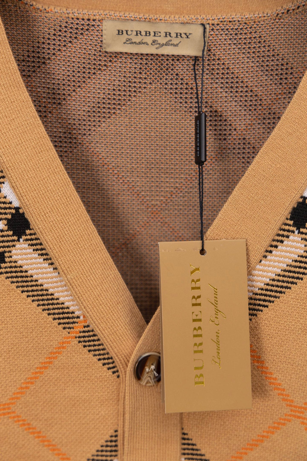 Burberry tan plaid cardigan neck tag with buttoned V-neck placket