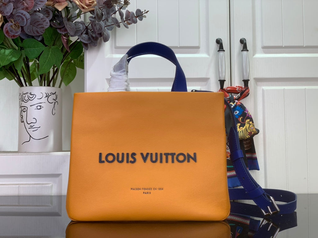 Louis Vuitton handbag in orange with blue leather handles and front logo.