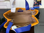 Orange handbag interior with beige lining, blue straps, and silver clasps.
