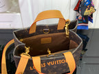 Tote bag with tan leather trim, gold hardware, and monogram canvas exterior.