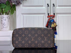 Tote bag with brown monogram canvas and tan strap, side profile.