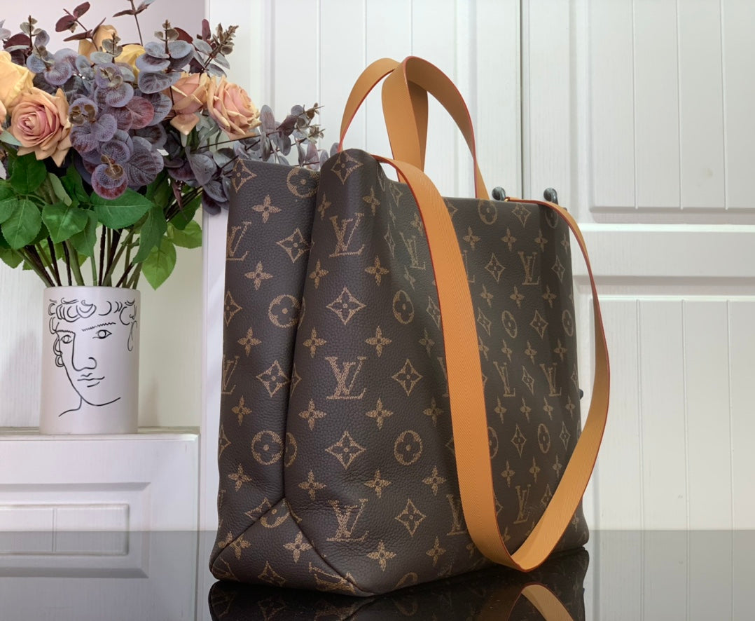 Louis Vuitton monogram tote bag with tan shoulder strap and zip top