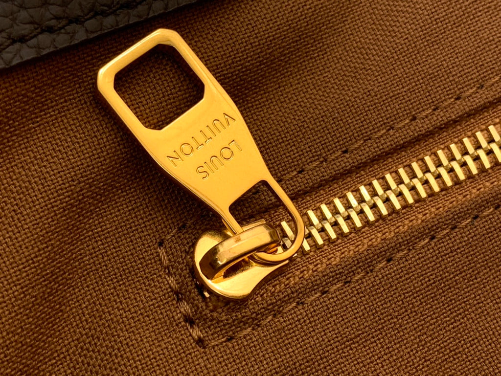 Louis Vuitton bag zipper pull and track with gold hardware detail