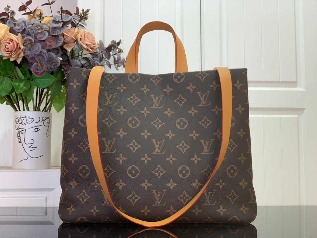 Louis Vuitton monogram tote bag with tan leather trim and rounded top handles