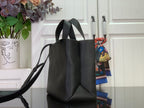 Louis Vuitton leather tote bag side view with long shoulder strap, black