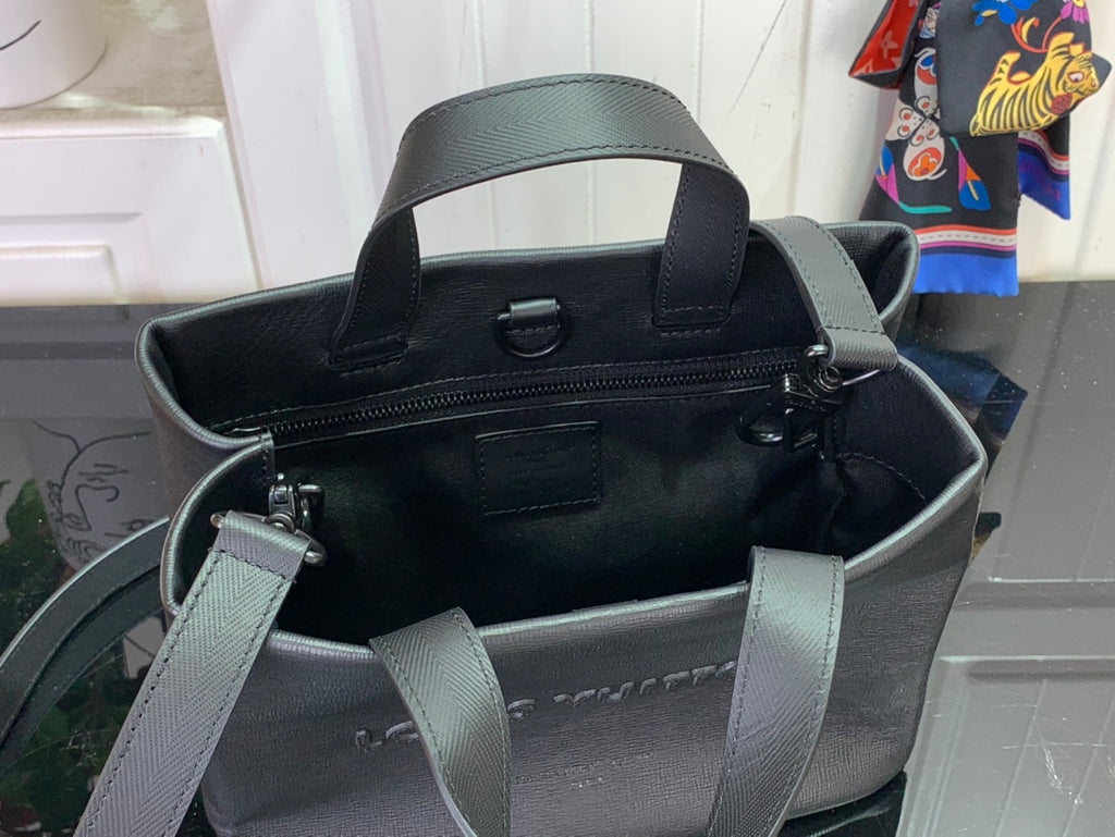 Louis Vuitton tote bag interior view with open top, pockets, and dual straps