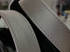 Louis Vuitton leather strap with visible stitching, dark black